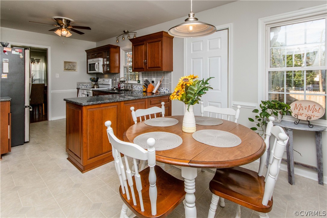 5512 Gatebridge Road North Chesterfield, VA 23234 - Photo 7 of 23 a dining room filled chandelier and kitchen view