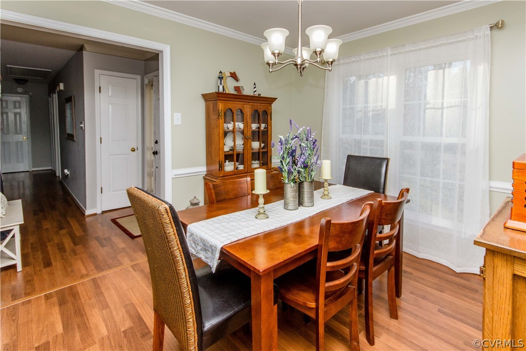 5512 Gatebridge Road North Chesterfield, VA 23234 - Photo 10 of 23 a view of a dining room with furniture a chandelier and wooden floor