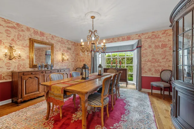 a living room with furniture a fireplace and large windows