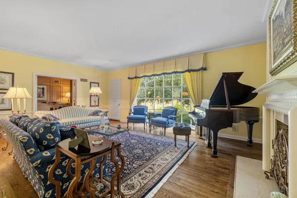 a living room with furniture and a piano