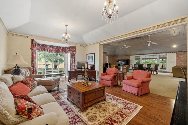 a living room with furniture a fireplace and a large window