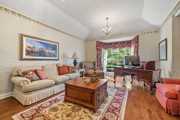 a living room with furniture fireplace and a chandelier