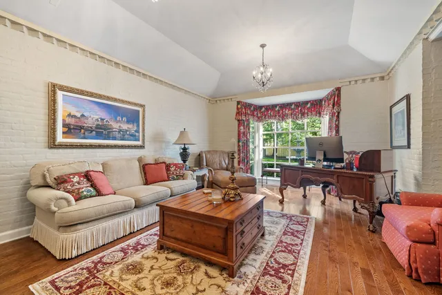 a living room with furniture fireplace and a chandelier