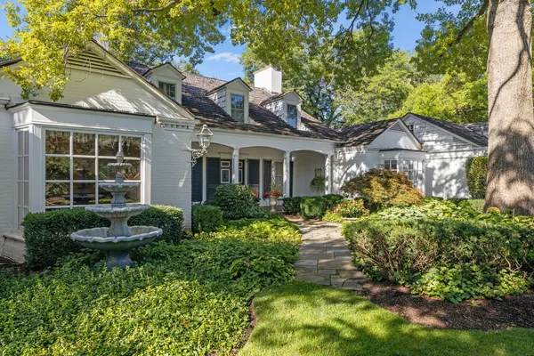 a front view of a house with a garden