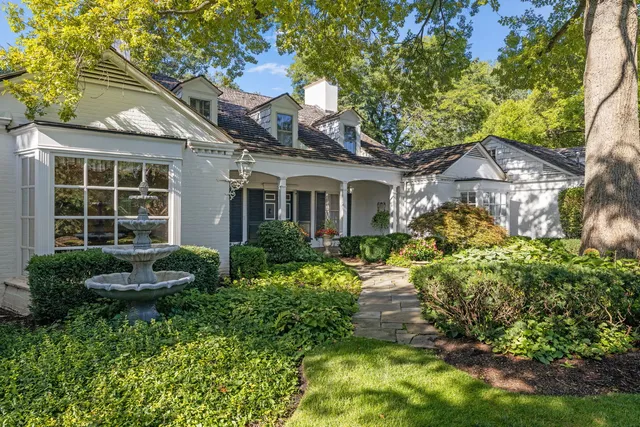 a front view of a house with a garden