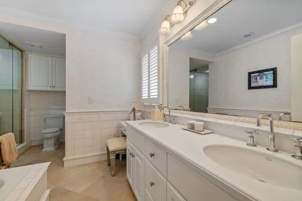 a bathroom with a tub sink and mirror