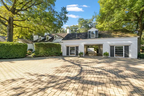 a view of a backyard with large trees