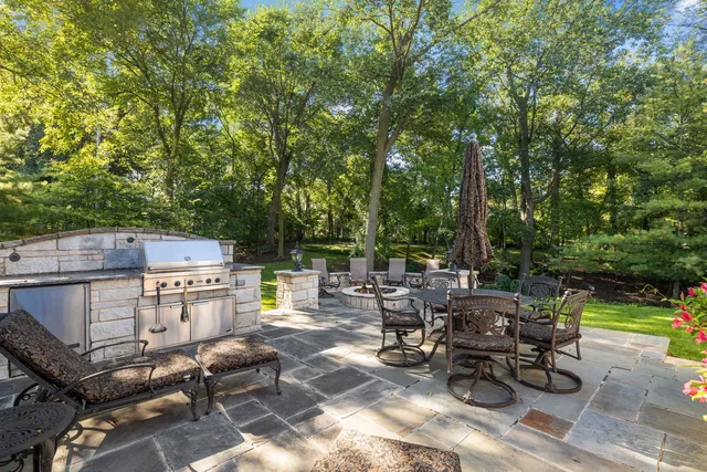 a backyard of a house with fire pit and outdoor seating