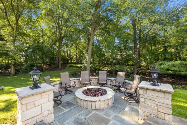 a view of house with backyard and sitting area
