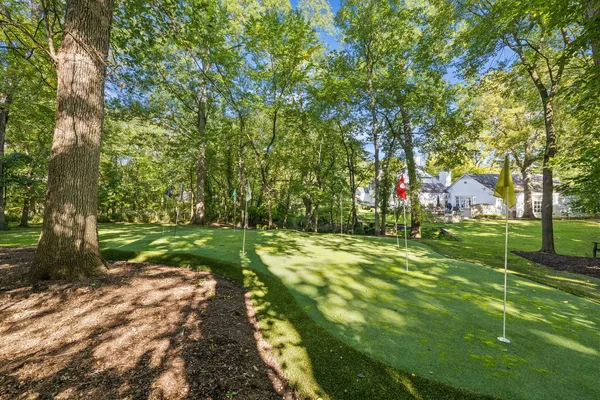 a swimming pool with trees in the background