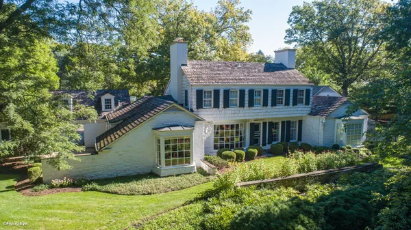 an aerial view of a house with a yard and outdoor seating