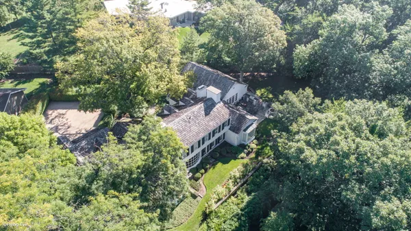 a backyard of a house with lots of green space and fountain
