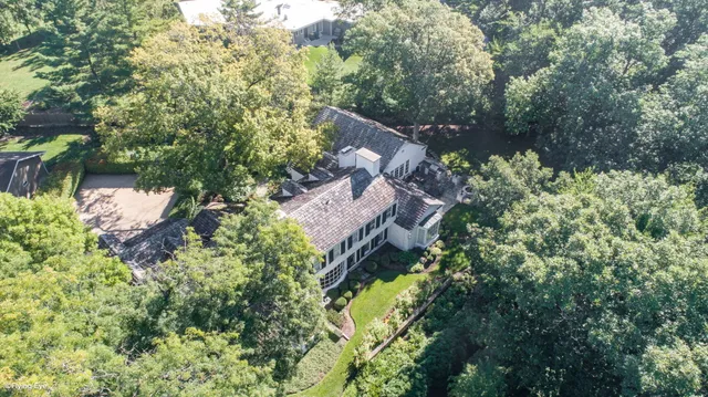 a backyard of a house with lots of green space and fountain