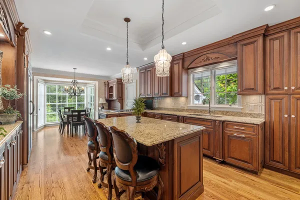 a kitchen with a stove sink and cabinets
