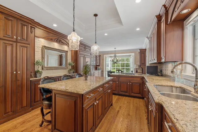 a kitchen with granite countertop a sink a counter space appliances and cabinets