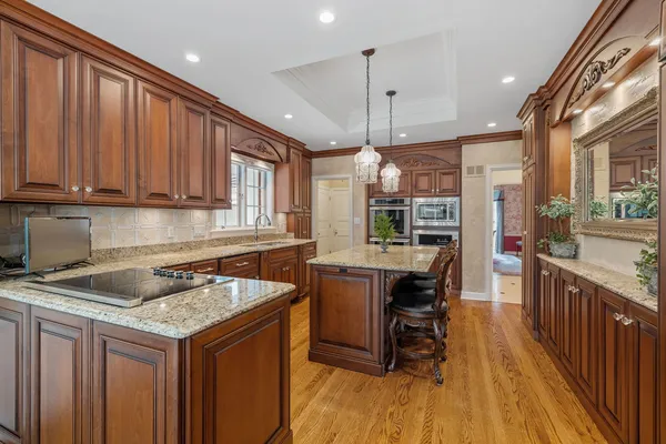 a dining room with furniture a chandelier and wooden floor
