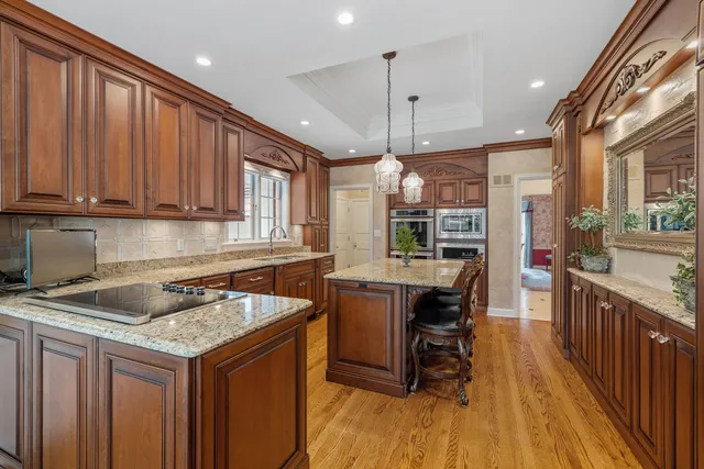 a dining room with furniture a chandelier and wooden floor