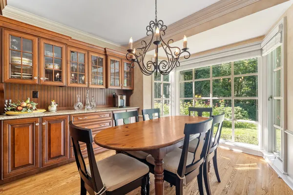 a view of a dining room with furniture window and wooden floor