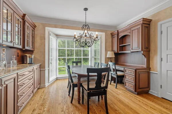 a bathroom with a granite countertop sink a toilet and a mirror