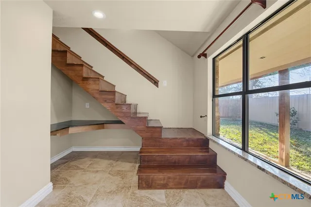 a view of entryway and hall with wooden floor
