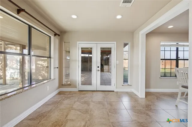 a view of empty room with windows