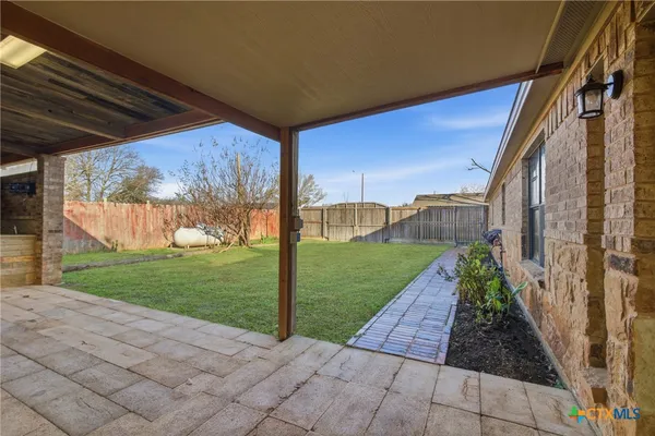 a view of backyard with tub and wooden fence