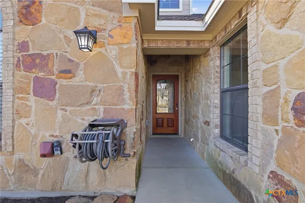 a view of entryway and hall with dining area