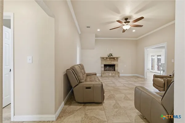 a living room with furniture and a ceiling fan