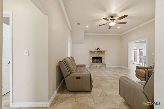 a living room with furniture and a ceiling fan
