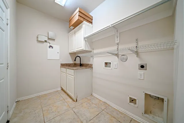 a kitchen with cabinets and white appliances