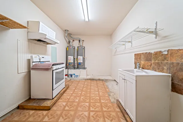 a storage room with wooden floor washer and dryer