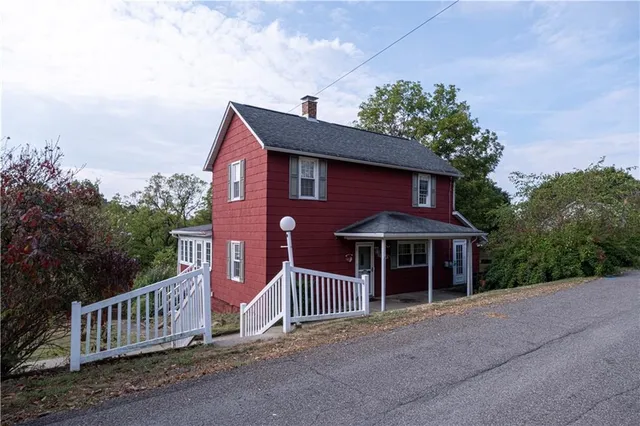 a front view of a house with yard and porch