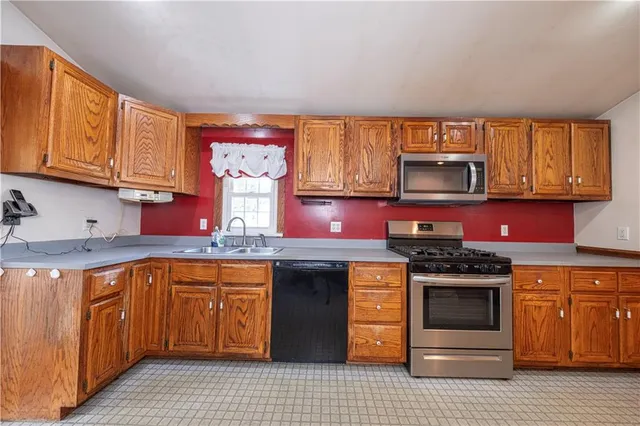 a kitchen with stainless steel appliances granite countertop wooden cabinets a sink and dishwasher