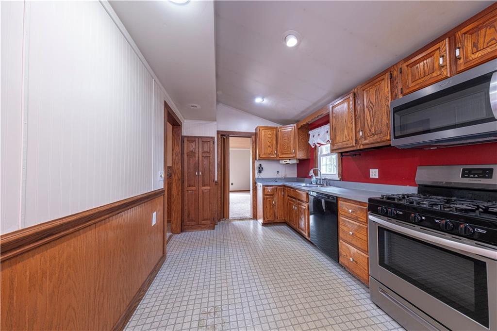 1645 Brown Road Ellwood City, PA 16117 - Photo 15 of 35 a kitchen with stainless steel appliances granite countertop a stove a sink and a refrigerator