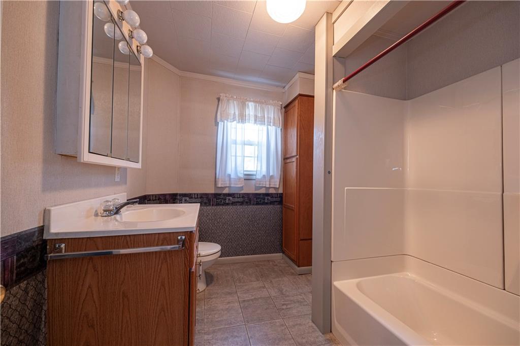 1645 Brown Road Ellwood City, PA 16117 - Photo 20 of 35 a bathroom with a tub sink and mirror