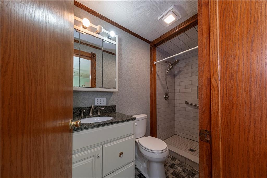 1645 Brown Road Ellwood City, PA 16117 - Photo 22 of 35 a bathroom with a granite countertop sink toilet and shower