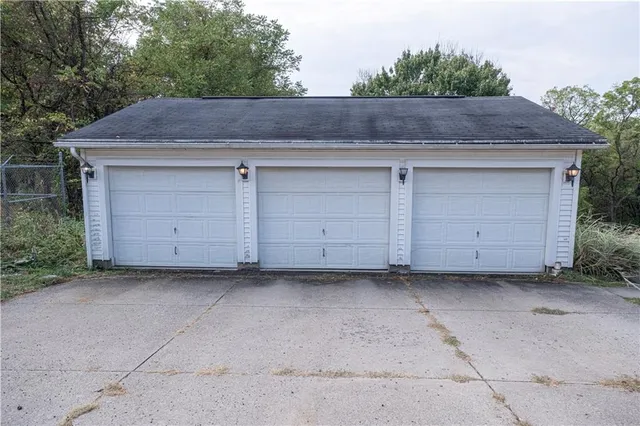 a view of outdoor space garage and wooden fence