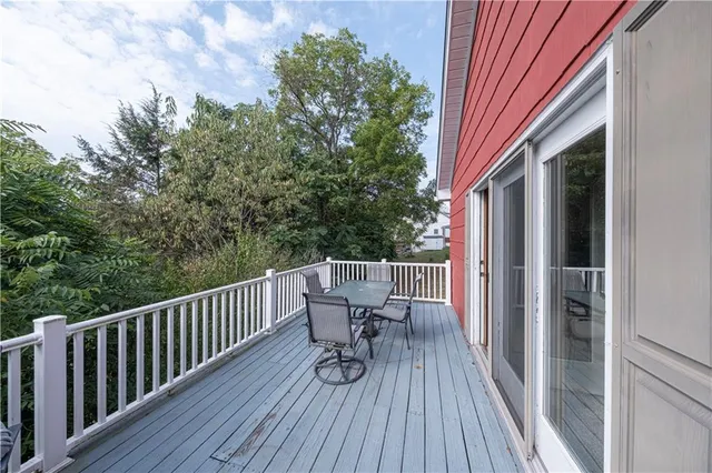 a view of balcony with furniture and wooden floor