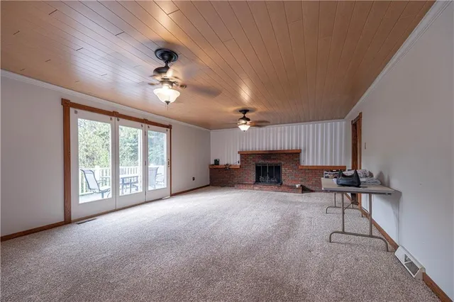a view of a livingroom with furniture and a fireplace