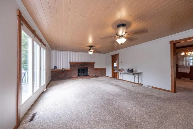 a view of empty room with fireplace and fan