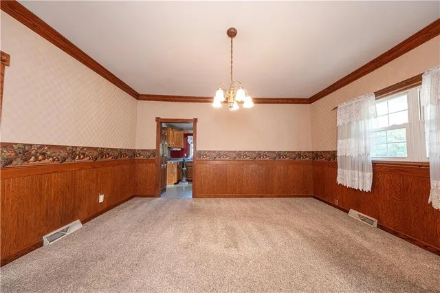 a view of a kitchen with microwave and refrigerator