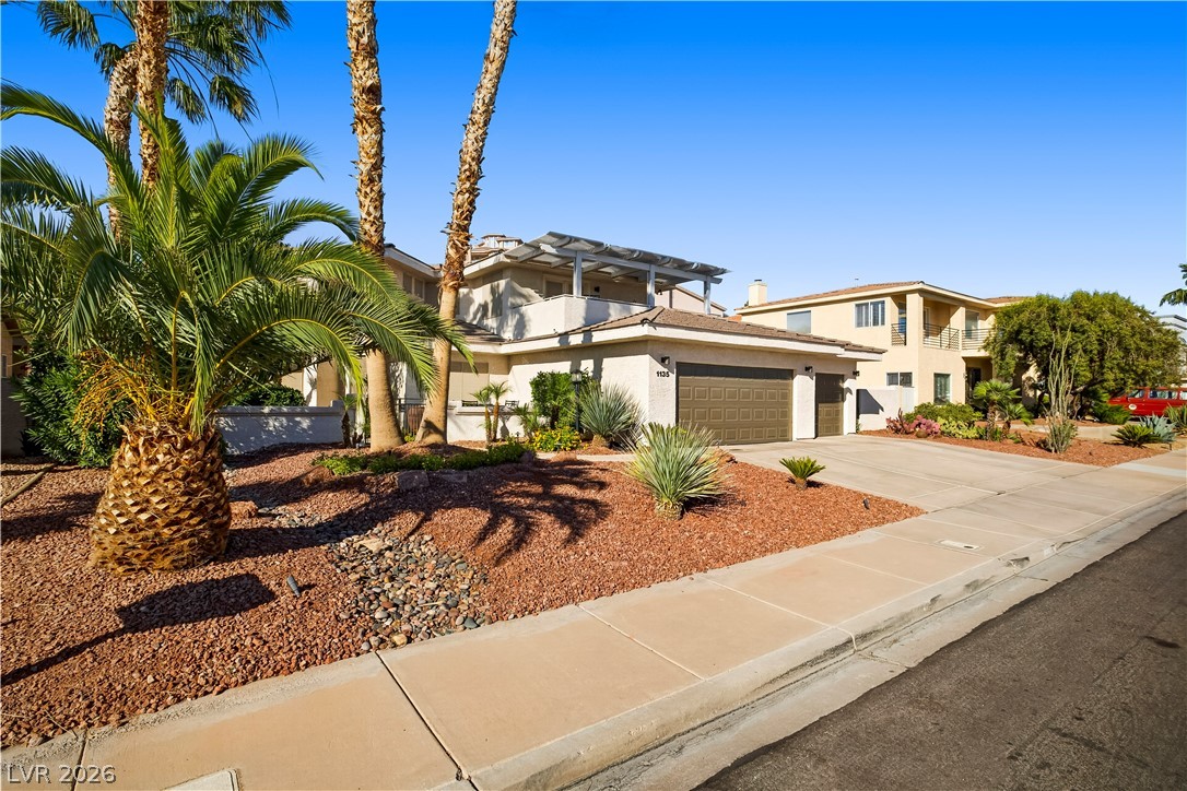1135 Calico Ridge Drive Henderson, NV 89011 - Photo 4 of 86 A desert oasis with mature palms, an enclosed court yard patio, and a spacious garage.