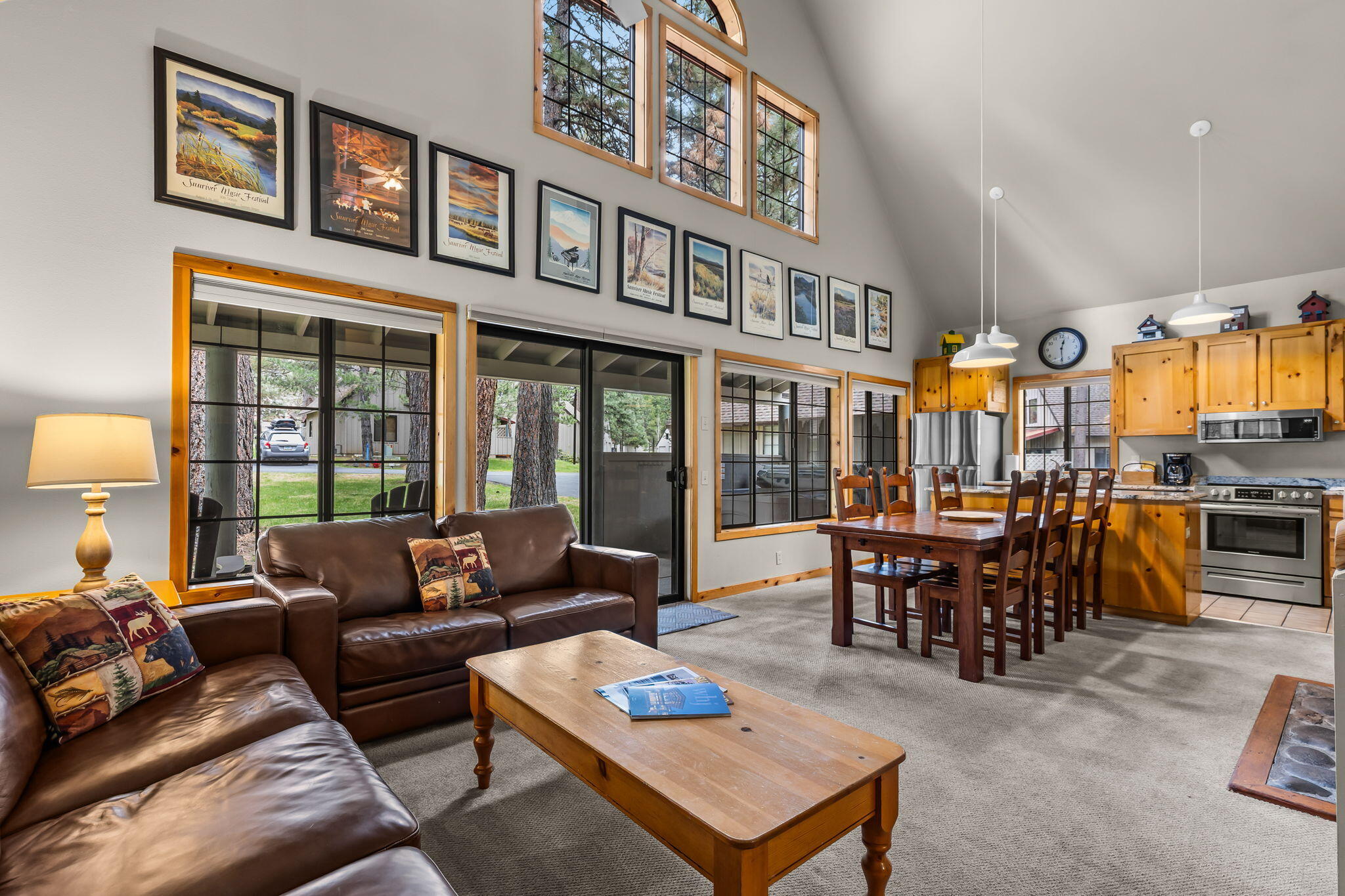 57505 Circle 4 Cabin Road, Unit 29 Sunriver, OR 97707 - Photo 9 of 35 a living room with furniture a dining table and a floor to ceiling window