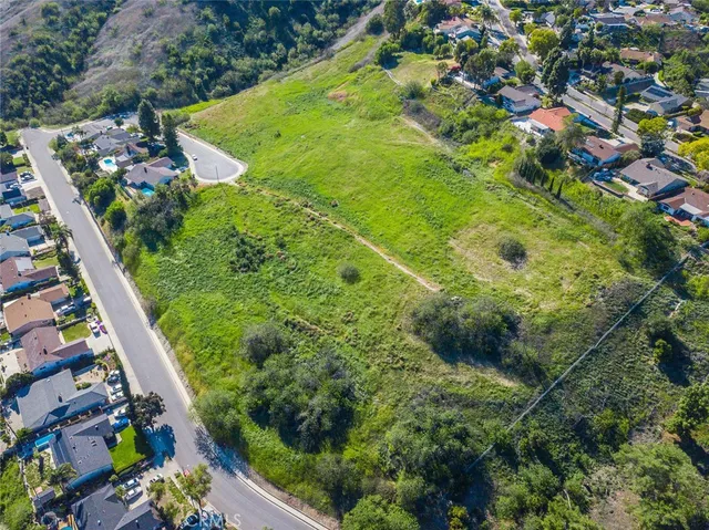 a view of a large building with a green field