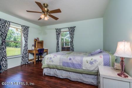 1930 Forbes Road St. Augustine, FL 32092 - Photo 16 of 24 a bedroom with a bed and a table