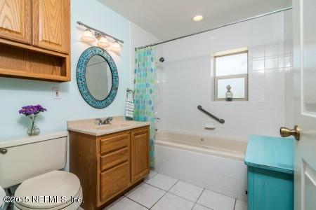 1930 Forbes Road St. Augustine, FL 32092 - Photo 18 of 24 a bathroom with a sink a mirror and a toilet