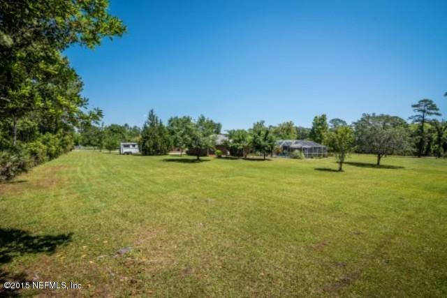 1930 Forbes Road St. Augustine, FL 32092 - Photo 3 of 24 a view of a green field with trees in the background