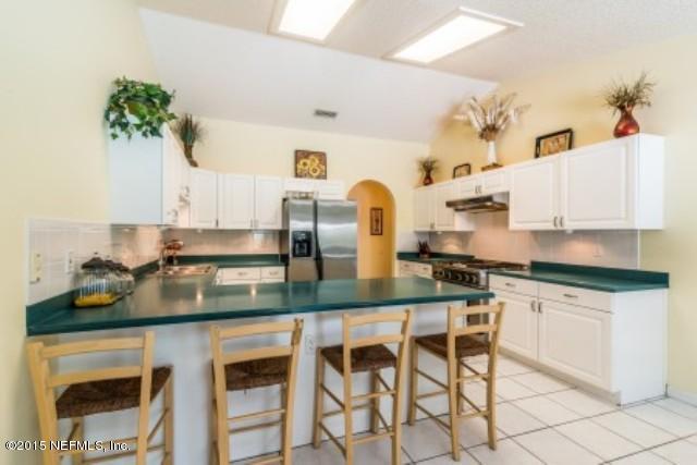 1930 Forbes Road St. Augustine, FL 32092 - Photo 6 of 24 a kitchen with stainless steel appliances granite countertop a white cabinets and stove top oven