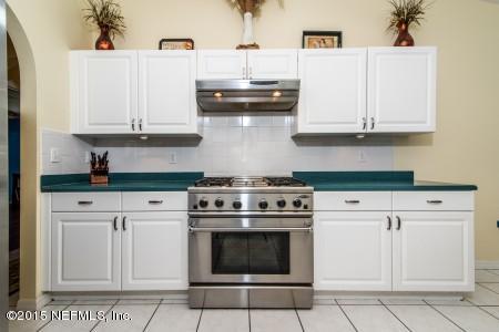 1930 Forbes Road St. Augustine, FL 32092 - Photo 7 of 24 a kitchen with granite countertop white cabinets and white appliances