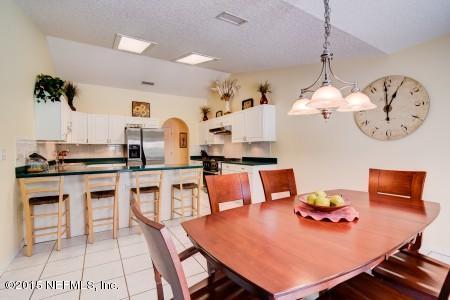 1930 Forbes Road St. Augustine, FL 32092 - Photo 8 of 24 a living room with stainless steel appliances kitchen island granite countertop furniture and a view of kitchen